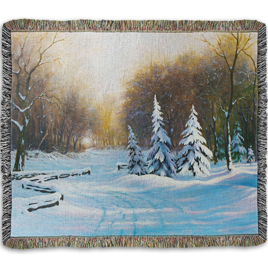 Woven blanket with a winter landscape design featuring trees and snow.