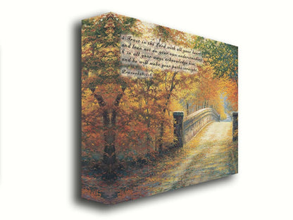 A painting looking down a bridge road during fall. The trees lining the road have turned yellow and orange for autumn, and some of their fallen leaves are scatted along the path. It is overlayed in the upper left with Proverbs 3:5-6 of the Bible, reading "5. Trust in the Lord with all your heart and lean not on your own understanding; 6. In all your ways acknowledge him, and he will make your paths straight." Printed on canvas.