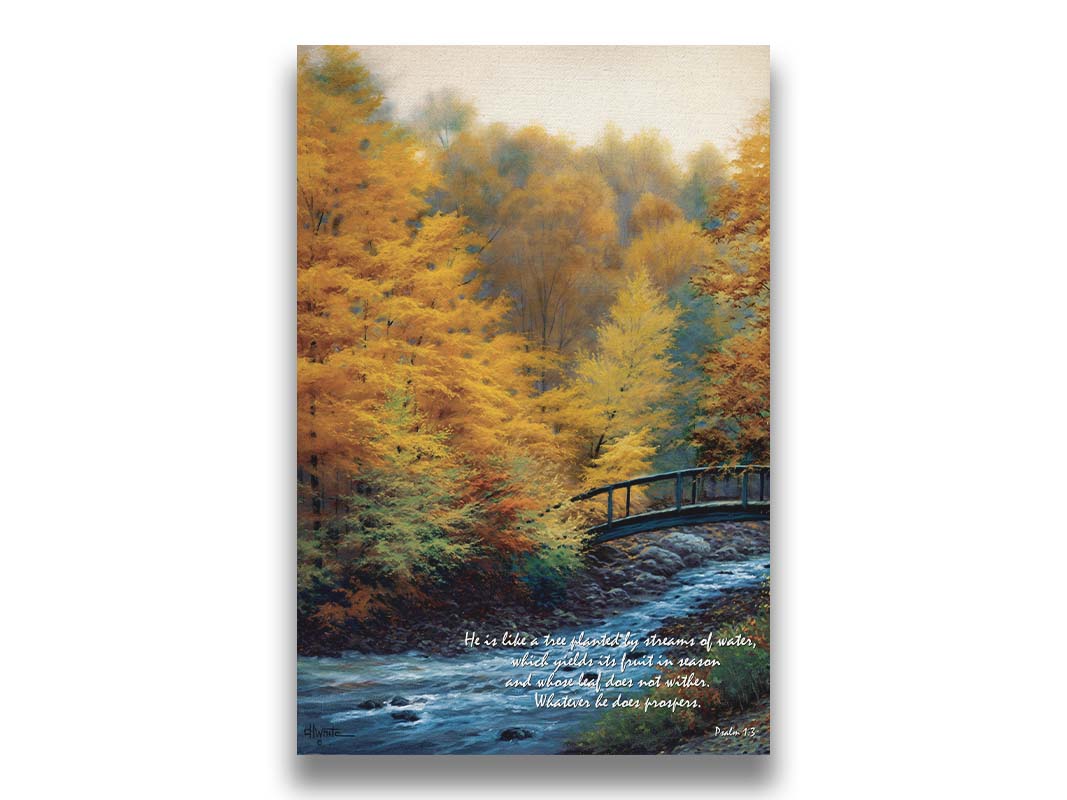 A painting of a forest stream, passing under an arched bridge. The trees are changing to yellow and orange for the fall season. The bottom right corner is overlaid with Psalm 1:3 in the Bible, reading "Psalm 1:3 from the Bible, reading "He is like a tree planted by streams of water, which yields its fruit in season and whose leaf does not wither. Whatever he does prospers." Printed on canvas.