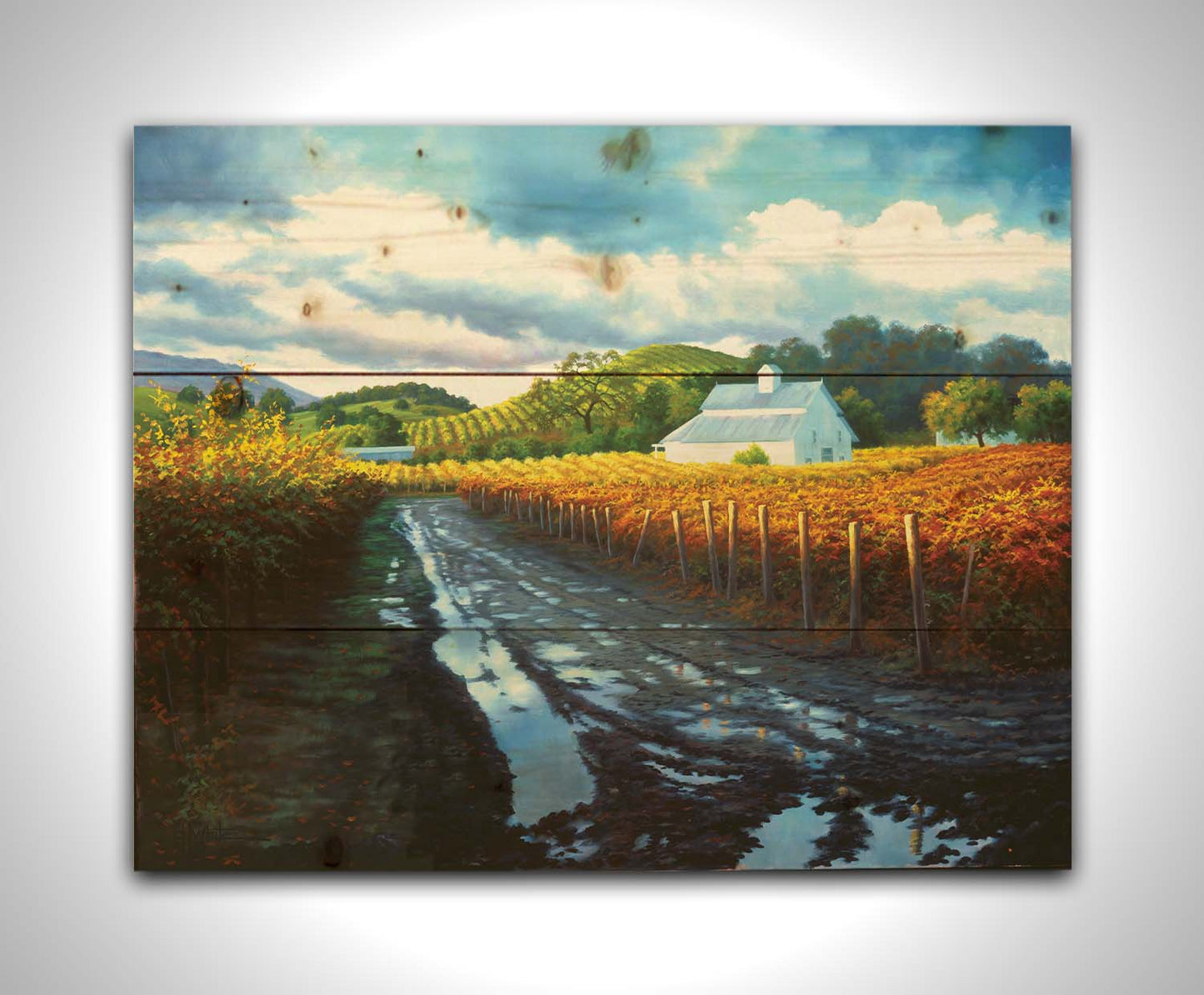 A painting looking down a road puddled with water. On either side, orange, red, and yellow grape vines grow in the vineyard. White barns and houses sit between the fields. Printed on a wood pallet.