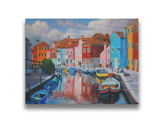 A painting of a canal in the Murano islands in Italy. Several small boats are docked along the sides, and bright, colorful buildings line the paths. Printed on canvas.