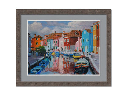 A painting of a canal in the Murano islands in Italy. Several small boats are docked along the sides, and bright, colorful buildings line the paths. Printed on paper, matted, and framed.