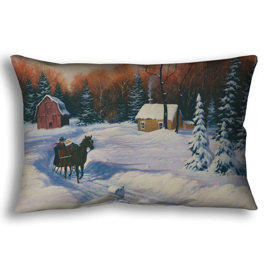 A throw pillow designed with a winter scene with a horse-drawn carriage, snow-covered landscape, and red barn.