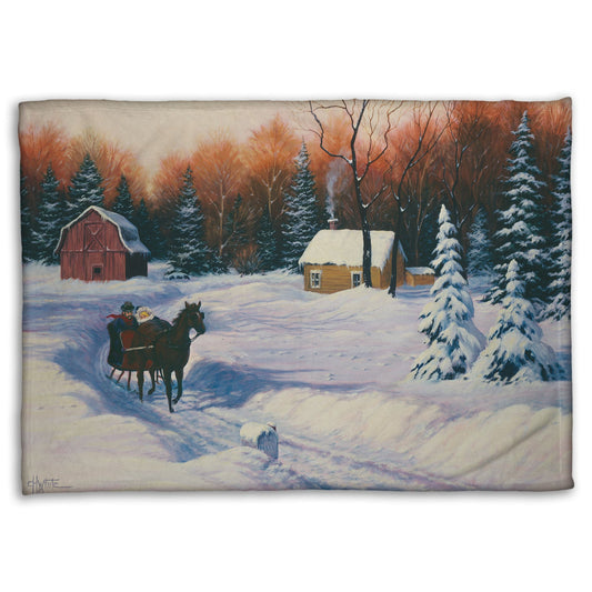 A coral fleece blanket designed with a winter scene with a horse-drawn carriage, snow-covered landscape, and red barn.