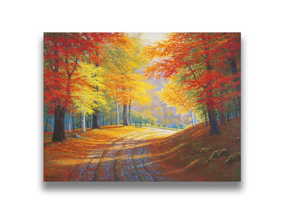 A painting of a gravel road through a forest in autumn. Orange red, and yellow leaves coat the ground and cover the trees, highlighted by bright sunlight. Printed on canvas.