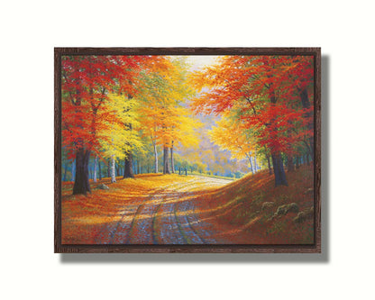 A painting of a gravel road through a forest in autumn. Orange red, and yellow leaves coat the ground and cover the trees, highlighted by bright sunlight. Printed on canvas in a float frame.