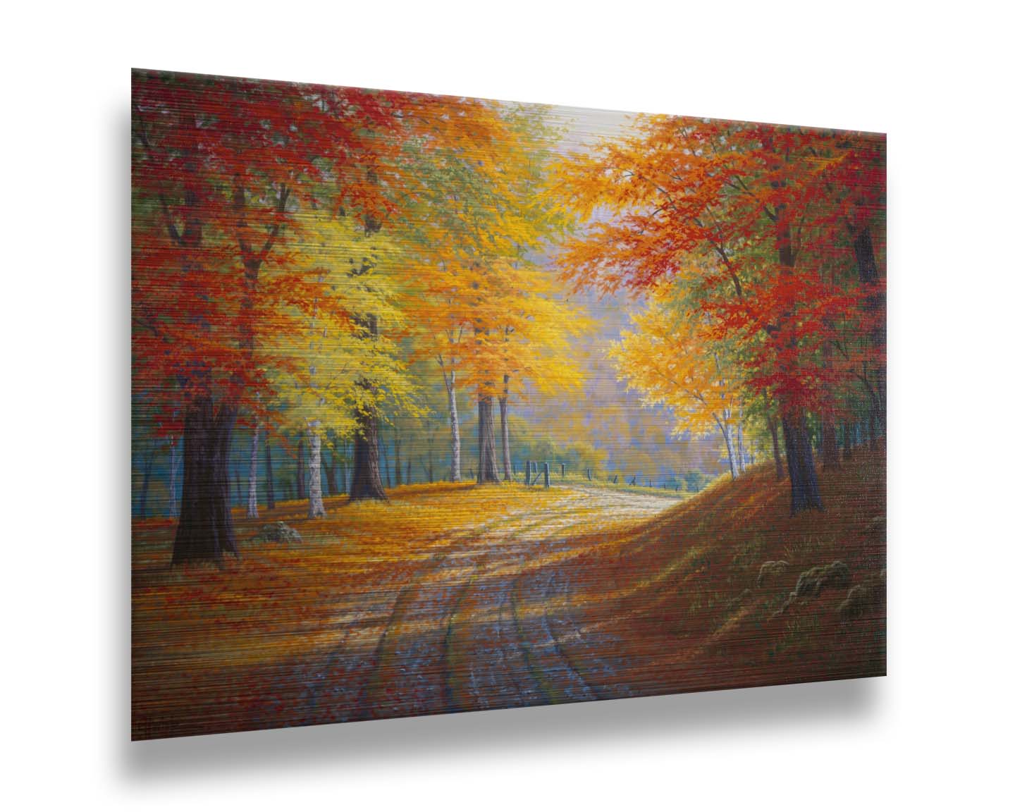 A painting of a gravel road through a forest in autumn. Orange red, and yellow leaves coat the ground and cover the trees, highlighted by bright sunlight. Printed on metal.