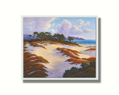 A painting of the Asilomar Dunes Natural Preserve in California. The white sand dune beach is complimented by red, green, and orange grasses. Printed on canvas in a float frame.