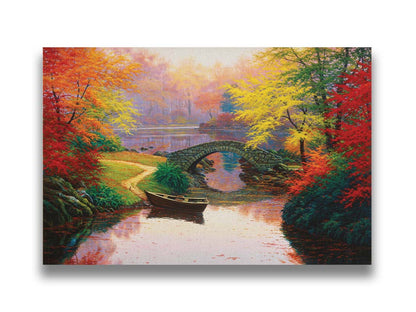 A painting of an idyllic fall scene, with colorful maples surrounding a river crossed by a small stone bridge. A rowboat is tied down near the bridge. Printed on canvas.