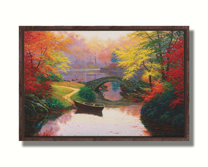 A painting of an idyllic fall scene, with colorful maples surrounding a river crossed by a small stone bridge. A rowboat is tied down near the bridge. Printed on canvas in a float frame.