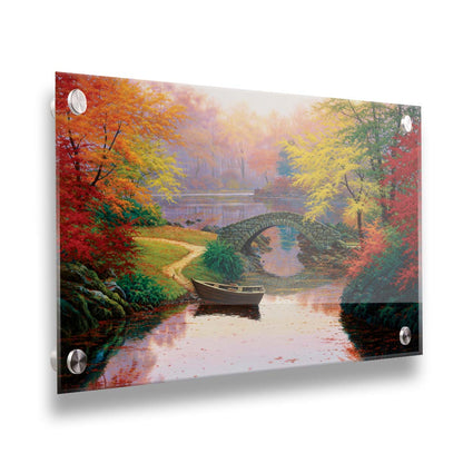 A painting of an idyllic fall scene, with colorful maples surrounding a river crossed by a small stone bridge. A rowboat is tied down near the bridge. Printed on acrylic.