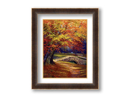 A painting of an autumn park, with the colorful trees dropping orange leaves onto the path below. A stone bridge crosses a small stream. Printed on paper, matted, and framed.