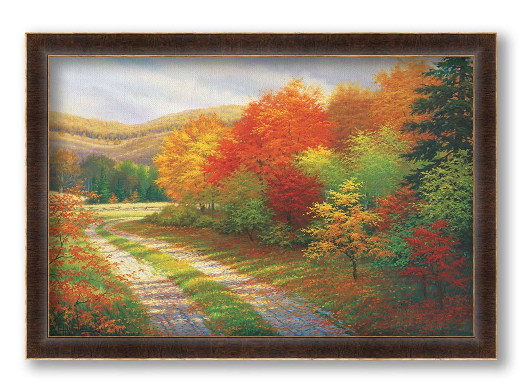 A painting of a forest in autumn, cut through by a gravel road curving into the distant fields and hills. Printed on canvas and framed.