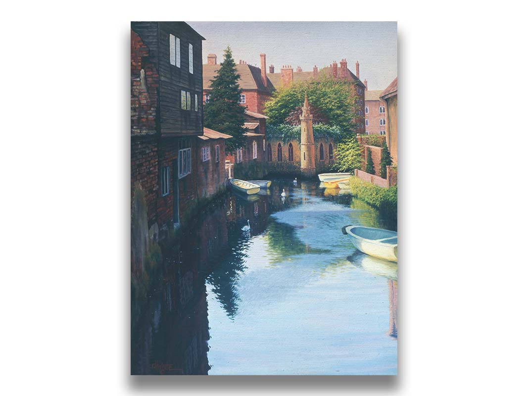 A painting of a canal in Canterbury in Kent, England. A few small row boats are docked along the waterway between historic red brick buildings. Printed on canvas.