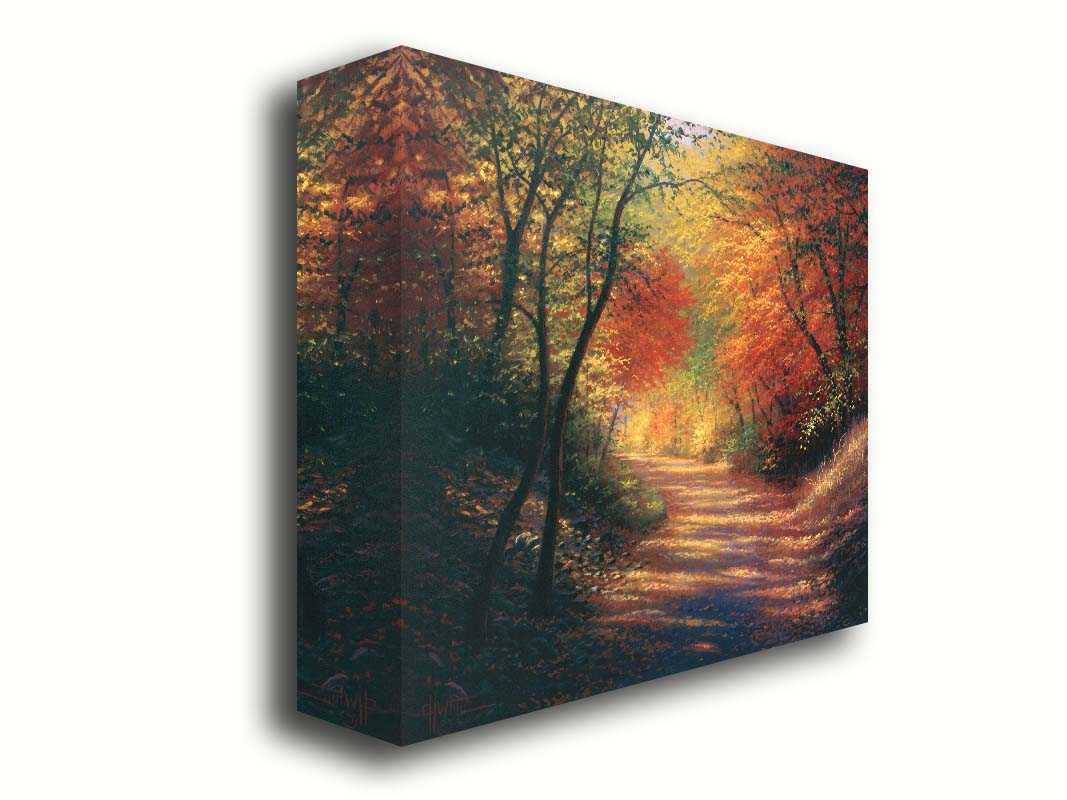 A painting of a path through the woods in autumn, with orange leaves falling onto the road. Printed on canvas.