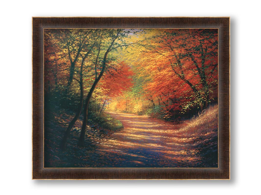 A painting of a path through the woods in autumn, with orange leaves falling onto the road. Printed on canvas and framed.