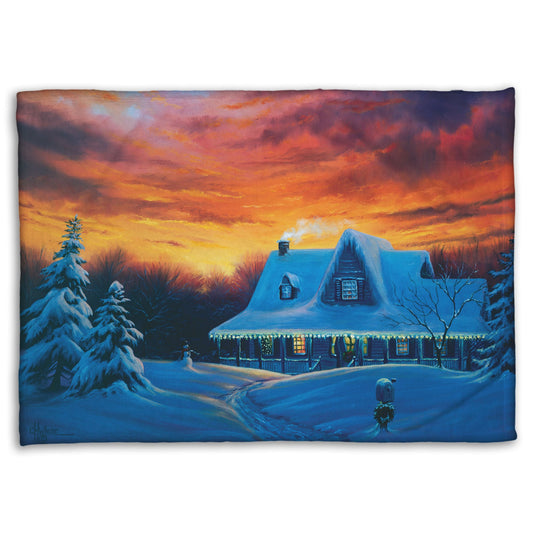 A coral fleece blanket designed with a painting of a house, decorated for Christmas, covered in and surrounded by snow.