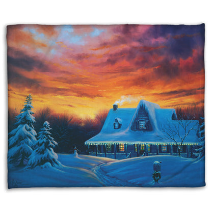 A coral fleece blanket designed with a painting of a house, decorated for Christmas, covered in and surrounded by snow.
