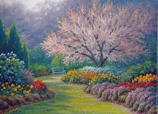 A painting of a grassy path through a garden, leading to a bench underneath a pink cherry blossom tree. A vast array of colorful flowers– such as red and yellow tulips, yellow daffodils, and lavender– line the path.