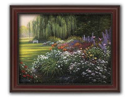 A painting of a garden filled with vibrant flowers, including lilies, carnations, poppies, and lavender. A serene white bench also sits under a weeping willow tree. Printed on canvas and framed.