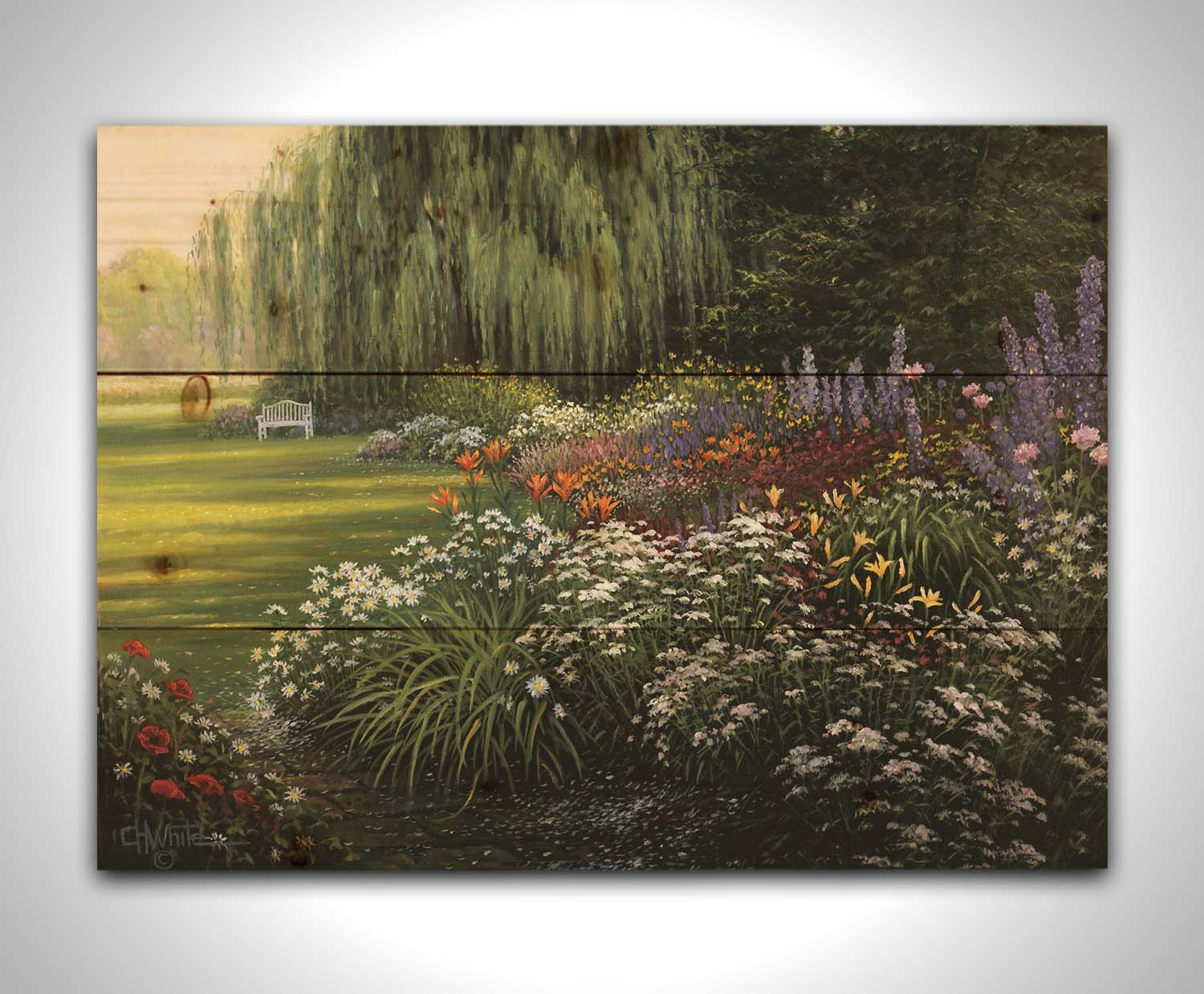 A painting of a garden filled with vibrant flowers, including lilies, carnations, poppies, and lavender. A serene white bench also sits under a weeping willow tree. Printed on a wood pallet.