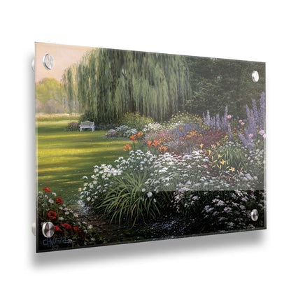 A painting of a garden filled with vibrant flowers, including lilies, carnations, poppies, and lavender. A serene white bench also sits under a weeping willow tree. Printed on acrylic.