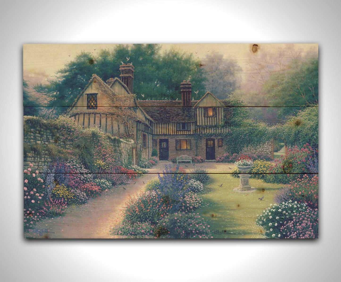 A painting of a cozy brown house surrounded by a vibrant and diverse display of flowers, including pink roses and lavender. Little birds search for seeds within the enchanting garden scene. Printed on a wood pallet.