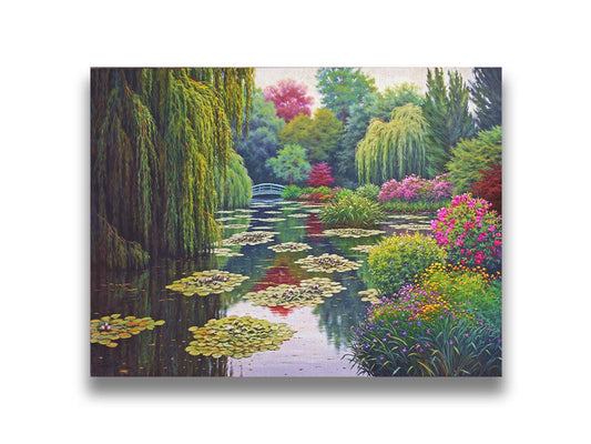 A painting of Claude Monet's garden at his home in Giverny, France. A pond dotted with lily pads is surrounded by weeping willows and colorful flower bushes in pinks, reds, yellows, and purples. Printed on canvas.