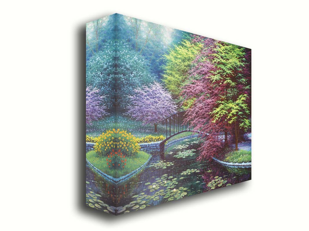 A painting of a peaceful garden pond covered in lily pads, and surrounded by vibrant red and yellow flowers, striking red maples, and blossoming white and pink trees. Printed on canvas.