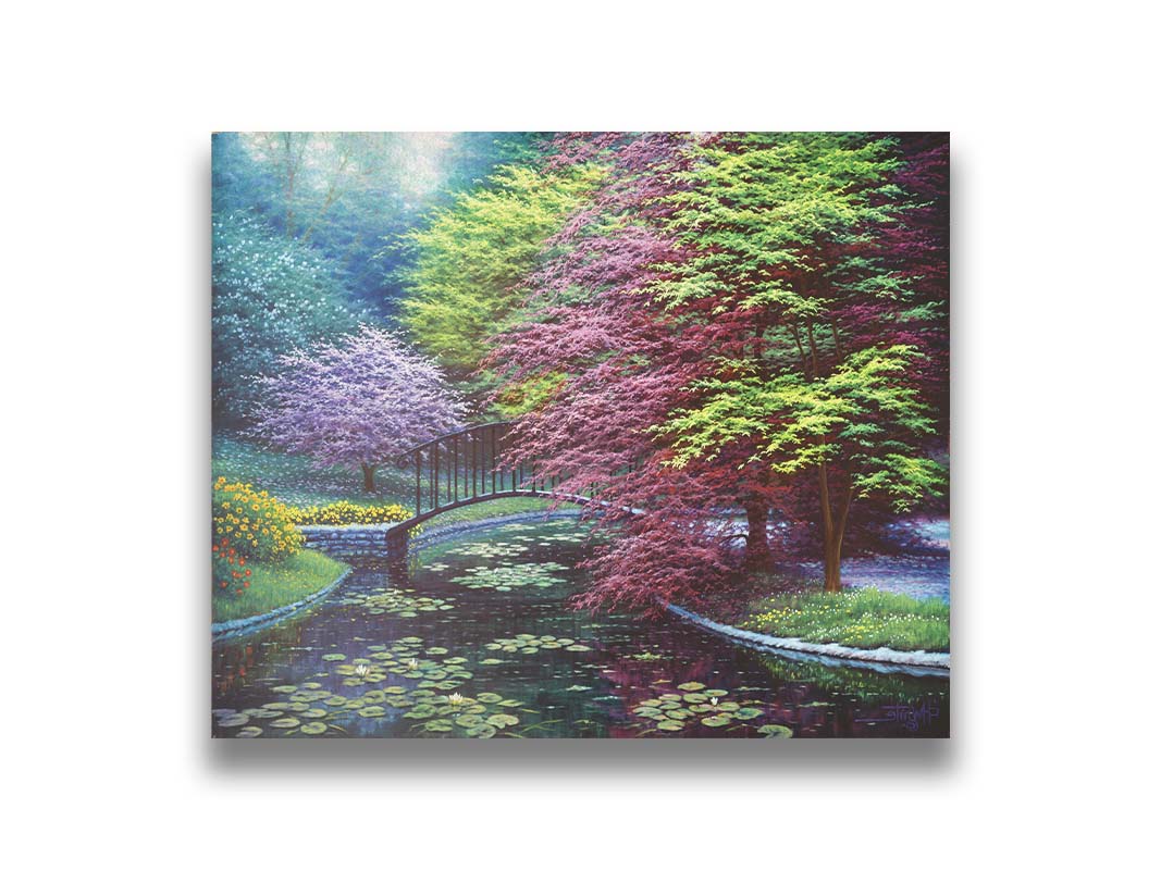 A painting of a peaceful garden pond covered in lily pads, and surrounded by vibrant red and yellow flowers, striking red maples, and blossoming white and pink trees. Printed on canvas.