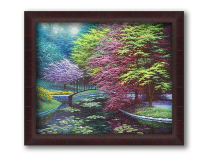 A painting of a peaceful garden pond covered in lily pads, and surrounded by vibrant red and yellow flowers, striking red maples, and blossoming white and pink trees. Printed on canvas and framed.