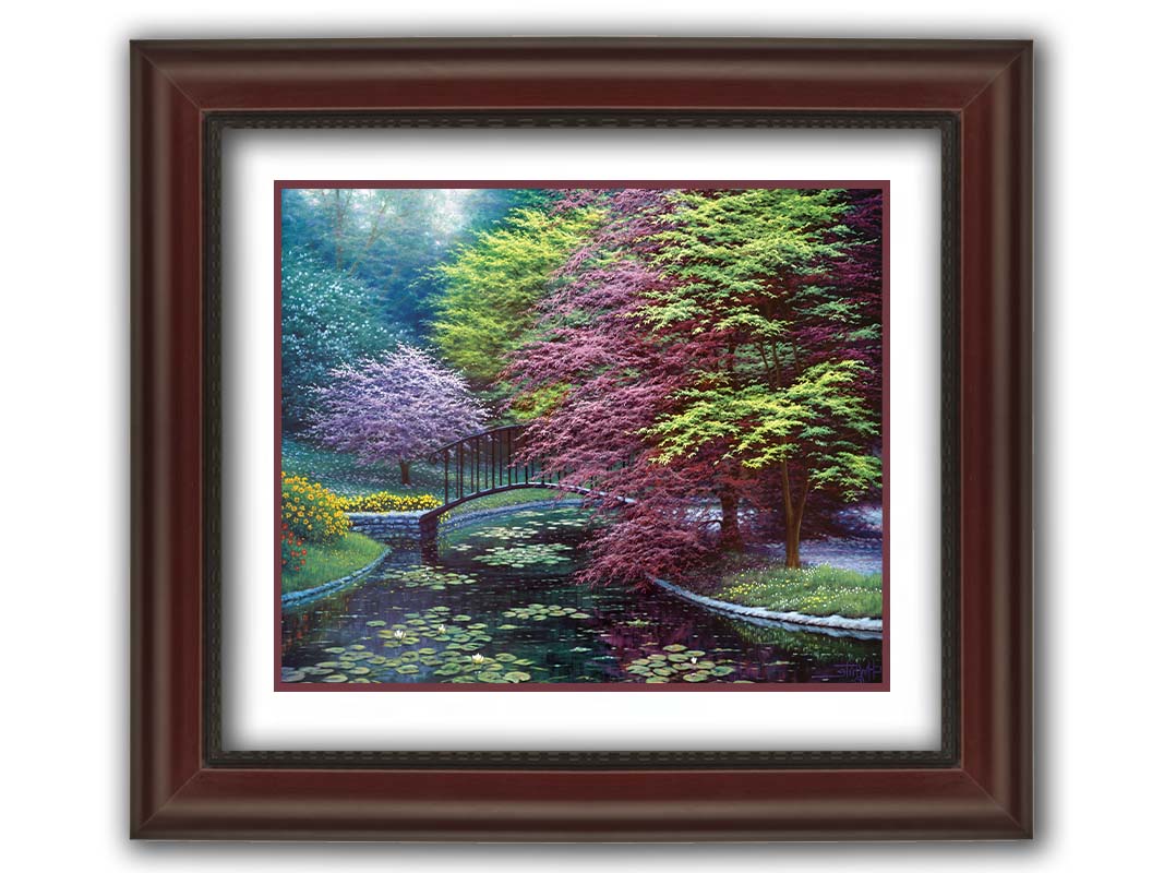 A painting of a peaceful garden pond covered in lily pads, and surrounded by vibrant red and yellow flowers, striking red maples, and blossoming white and pink trees. Printed on paper, matted, and framed.