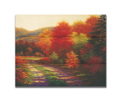 A painting of a forest in autumn, cut through by a gravel road curving into the distant fields and hills. Printed on a box board.