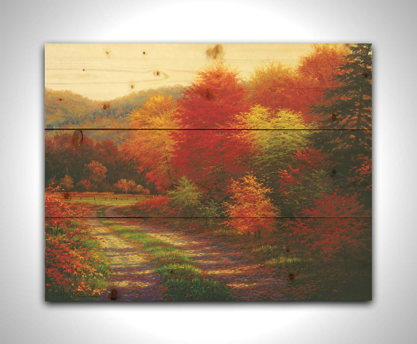 A painting of a forest in autumn, cut through by a gravel road curving into the distant fields and hills. Printed on a wood pallet.