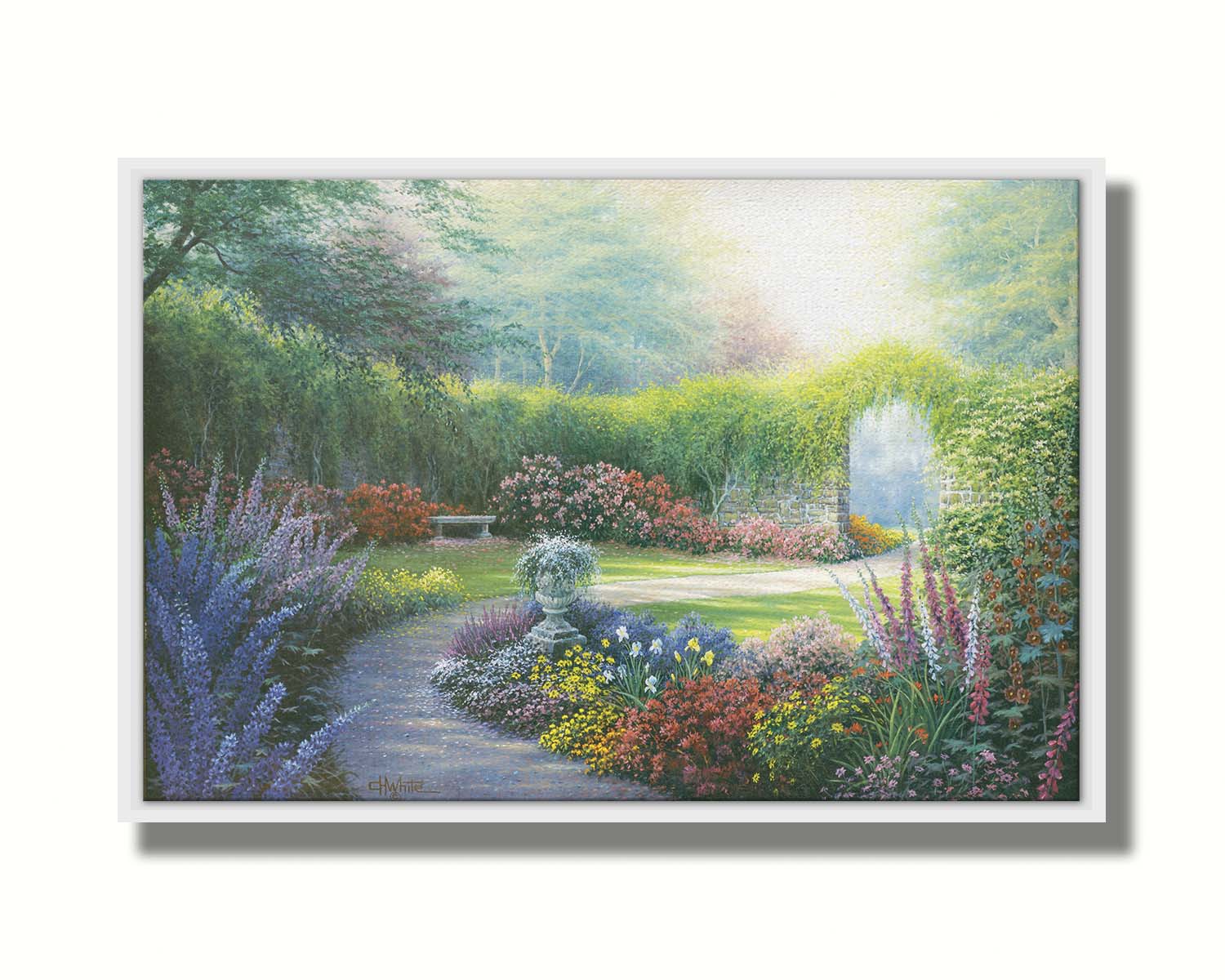 A painting of a path through a garden, filled with flowers in every color– including irises, foxgloves, butterfly bush, and more. A vine-covered stone wall with an archway surrounds the area. Printed on canvas in a float frame.