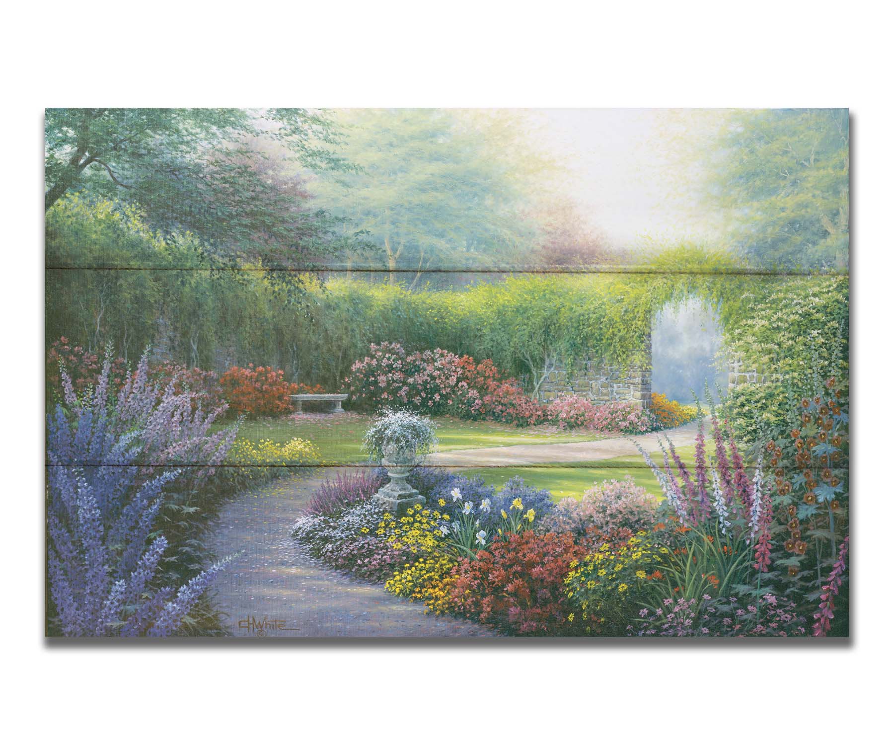 A painting of a path through a garden, filled with flowers in every color– including irises, foxgloves, butterfly bush, and more. A vine-covered stone wall with an archway surrounds the area. Printed on a box board.