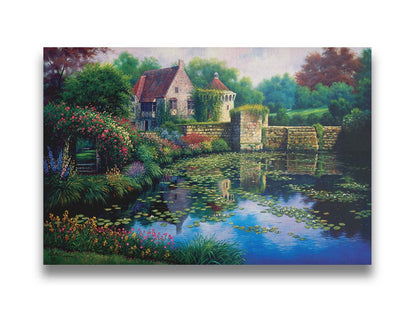 A painting of a pond covered in lily pads– bordered by a garden of flowers in every color, as well as an old stone wall covered in mosses and vines. Beyond it is a home with historic architecture, also supporting vines. The plants and structures are all well-maintained and not overgrown. Printed on canvas.