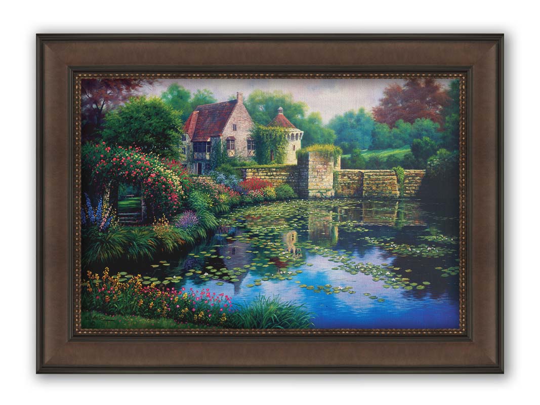 A painting of a pond covered in lily pads– bordered by a garden of flowers in every color, as well as an old stone wall covered in mosses and vines. Beyond it is a home with historic architecture, also supporting vines. The plants and structures are all well-maintained and not overgrown. Printed on canvas and framed.