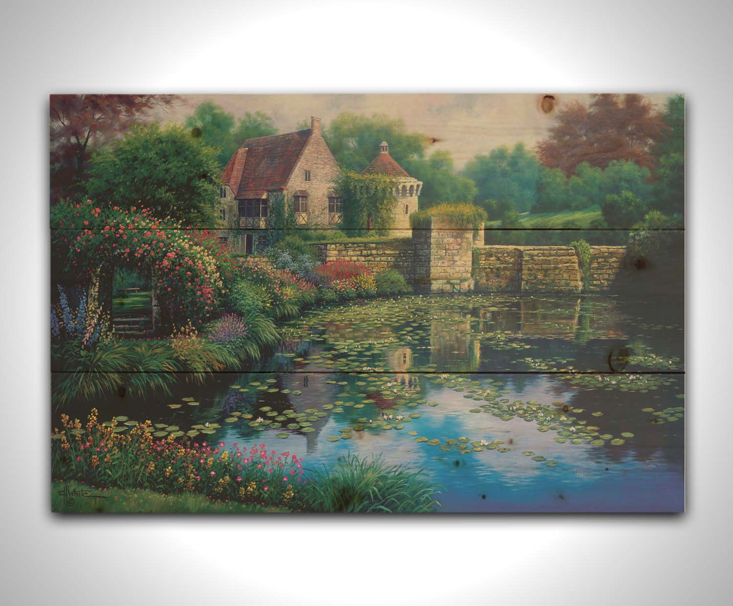 A painting of a pond covered in lily pads– bordered by a garden of flowers in every color, as well as an old stone wall covered in mosses and vines. Beyond it is a home with historic architecture, also supporting vines. The plants and structures are all well-maintained and not overgrown. Printed on a wood pallet.