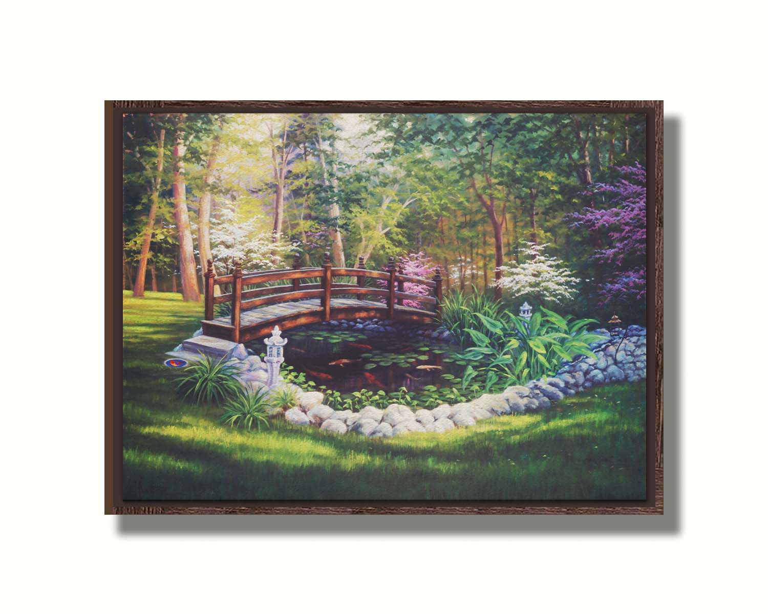 A painting of a garden koi pond, surrounded by stones and crossed by a small bridge. Lily pads grow in the water, and orange and white koi carp swim between them. Printed on canvas in a float frame.