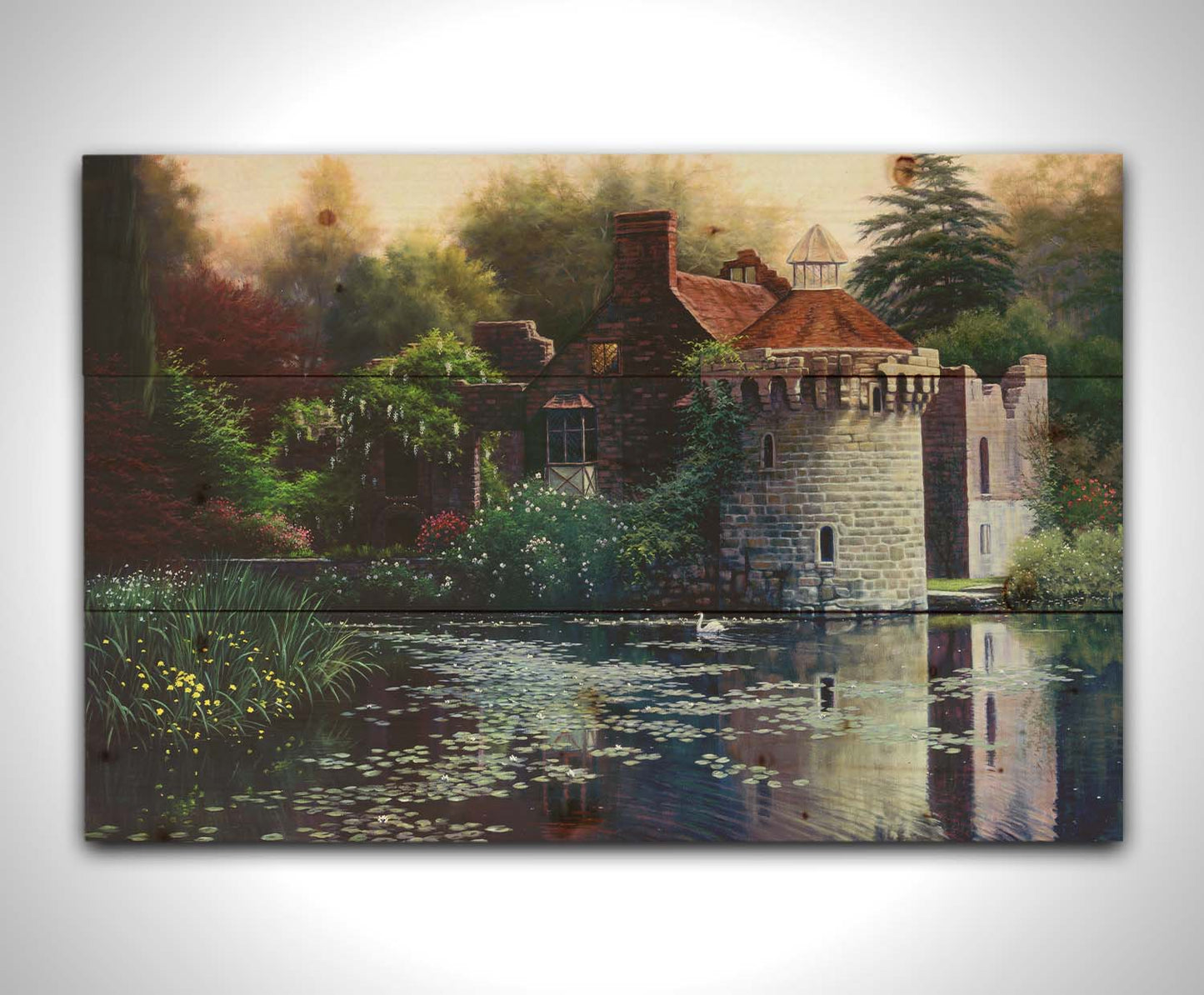 A painting of the ruins of a medieval house called Scotney Old Castle on an island lake in Kent, England. It is surrounded by a garden of azaleas, kalmia, rhododendrons, roses, wisteria, and other plants. Printed on a wood pallet.