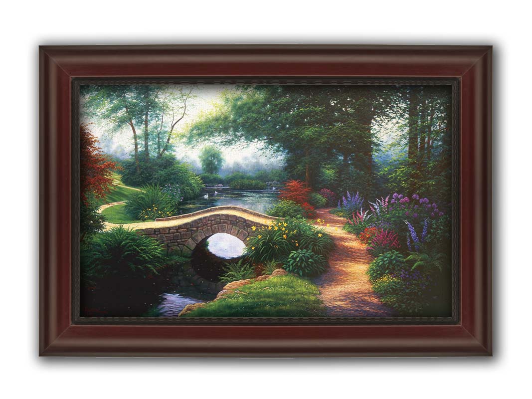 A painting of a serene garden path winding between flowers and trees. A stone bridge crosses over a tranquil pond inhabited by graceful swans. Printed on canvas and framed.