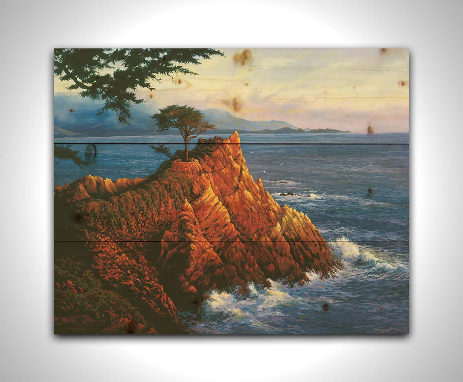 A painting of the historic lone cypress in Del Monte Forest, California at the coast of Carmel Bay on the peak of a coastal cliff. Printed on a wood pallet.