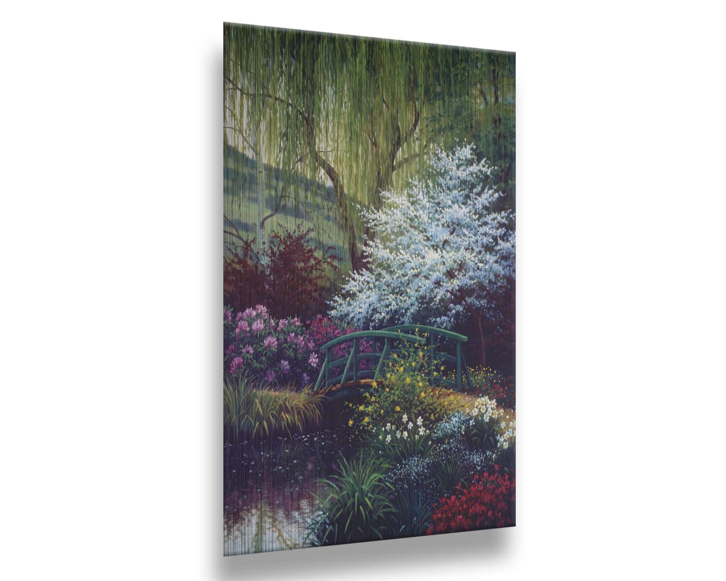 A painting of Claude Monet’s iconic water lily pond in Giverny, France, featuring a small bridge over the canal that brings water into the pond. It is surrounded by willow trees, trees with white and red blossoms, and a variety of flowers. Printed on metal.