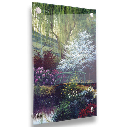 A painting of Claude Monet’s iconic water lily pond in Giverny, France, featuring a small bridge over the canal that brings water into the pond. It is surrounded by willow trees, trees with white and red blossoms, and a variety of flowers. Printed on acrylic.