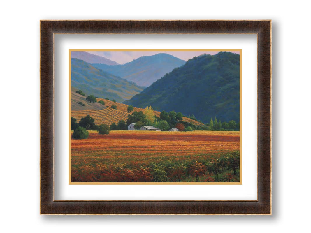 A landscape painting of the Napa Valley wine region in California. Colorful orange, red, and green vineyards are nestled among forested mountains. Printed on paper, matted, and framed.