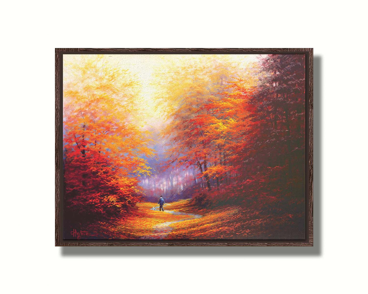 A painting of resplendent orange and red trees, a winding sidewalk through the woods, and a person walking their dog along the path. Printed on canvas in a float frame.