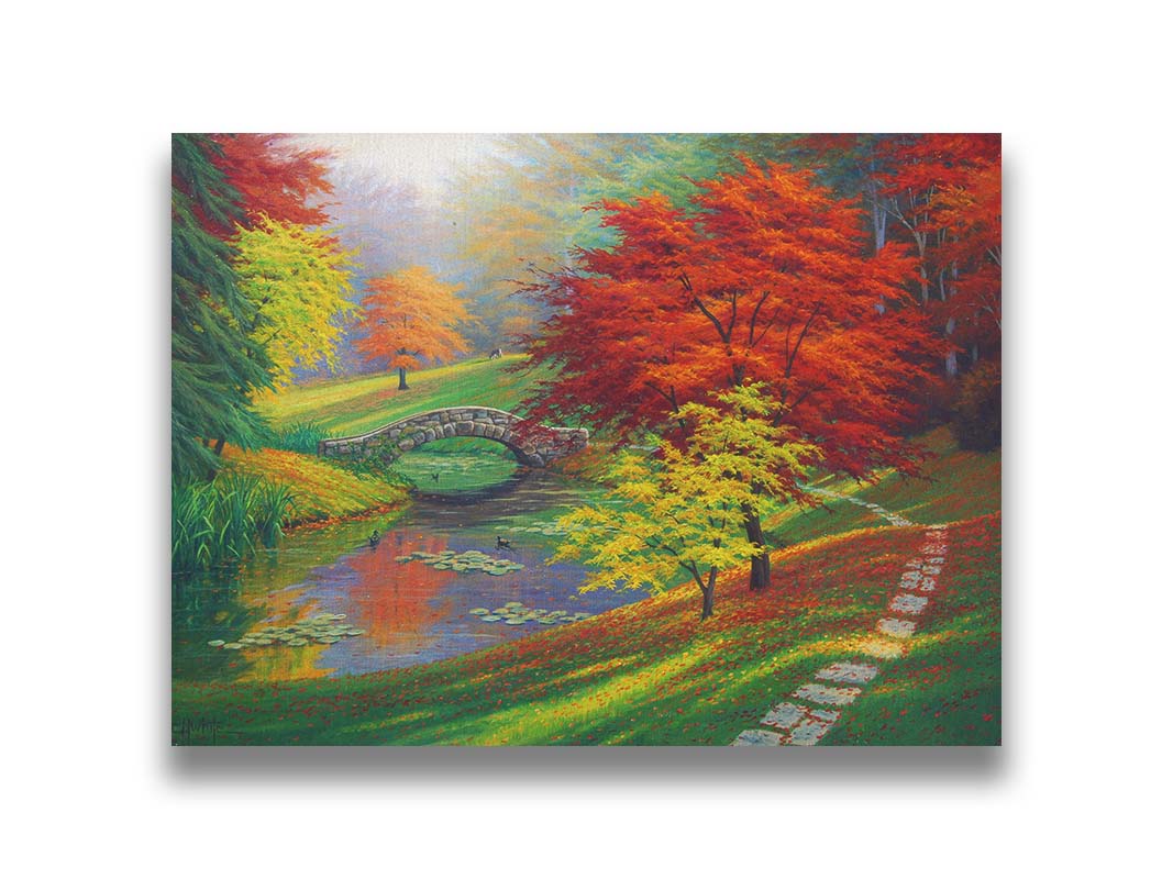 A painting of a fall park scene. Vibrant trees in hues of orange and red adorn the landscape while leaves gently fall. A stone bridge over a pond with lily pads and ducks. Printed on canvas.