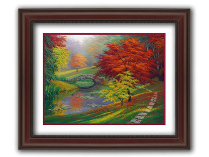 A painting of a fall park scene. Vibrant trees in hues of orange and red adorn the landscape while leaves gently fall. A stone bridge over a pond with lily pads and ducks. Printed on paper, matted, and framed.