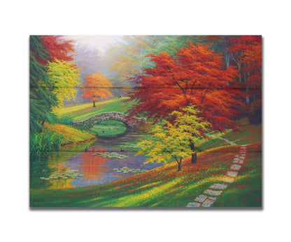 A painting of a fall park scene. Vibrant trees in hues of orange and red adorn the landscape while leaves gently fall. A stone bridge over a pond with lily pads and ducks. Printed on a box board.